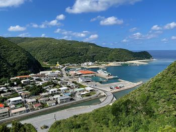 High angle view of sea and mountains against sky