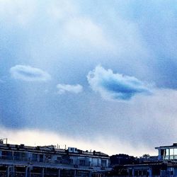 Low angle view of building against cloudy sky