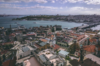 High angle view of townscape by sea against sky