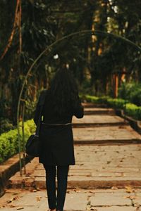 Rear view of woman standing in park