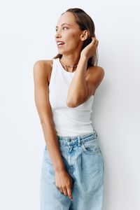 Young woman standing against white background