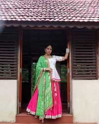 Side view of woman standing against sky