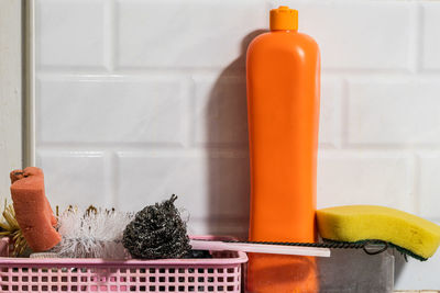 Close-up of orange on table against wall