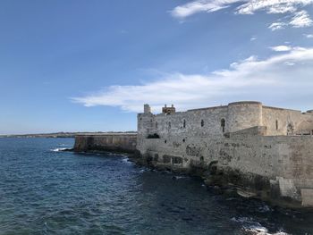 View of fort against blue sky, ortigia