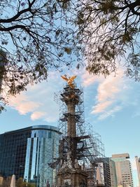 Low angle view of statue of building against cloudy sky