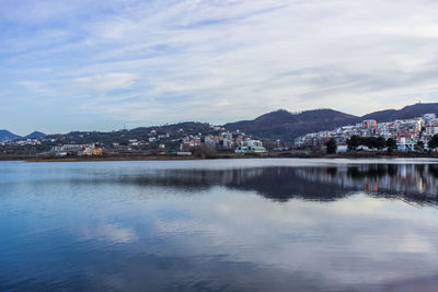 Scenic view of river and mountains against sky