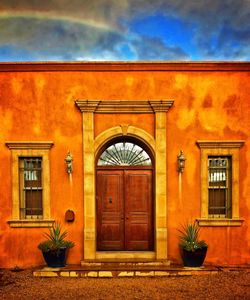 Facade of building against cloudy sky