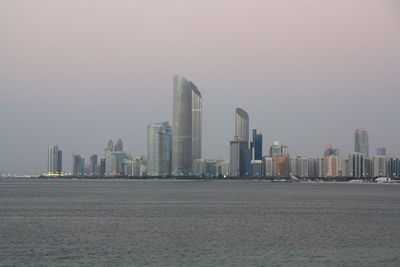 Skyscrapers in city at dusk