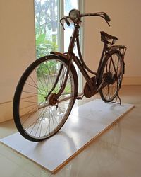 Side view of bicycle against white wall