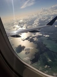 Aerial view of clouds seen through airplane window