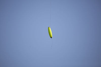 Low angle view of bird flying against clear sky