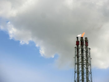 Low angle view of communications tower against sky