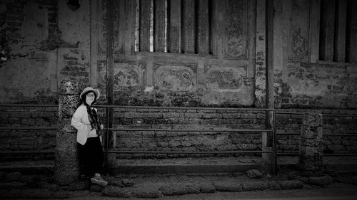 Woman standing against wall