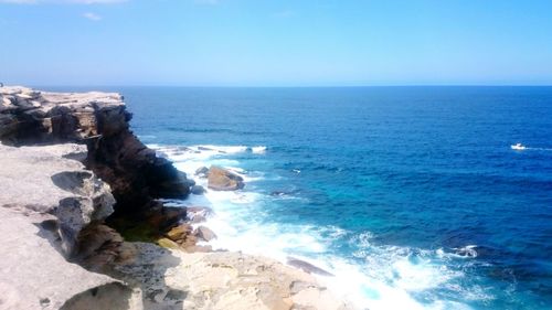 Scenic view of sea against blue sky