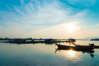 Boats in marina at sunset