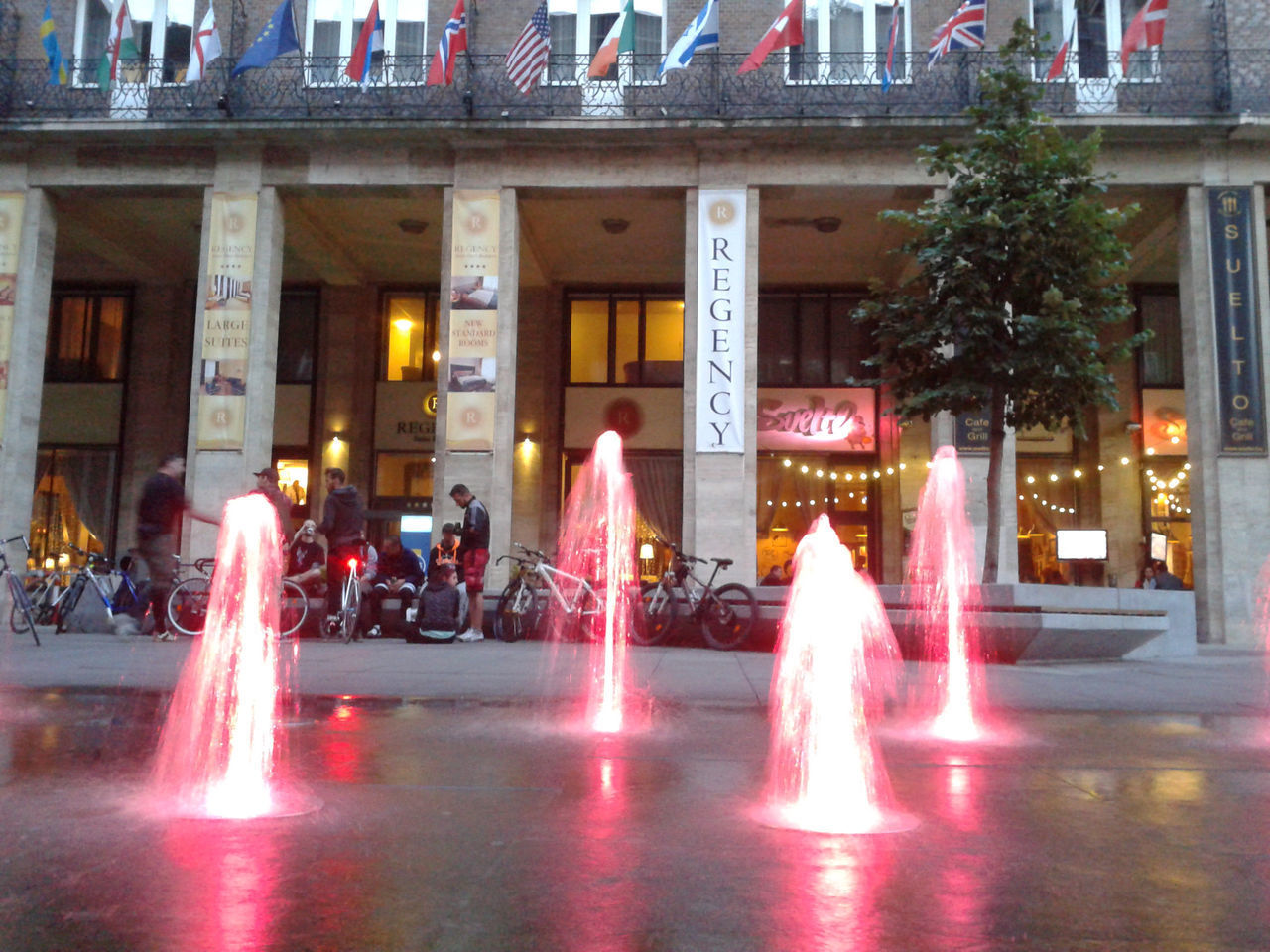 PEOPLE ON ILLUMINATED BUILDING AT NIGHT