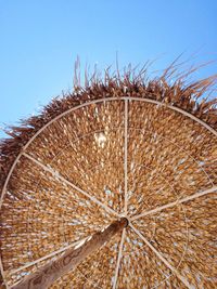 Low angle view of ferris wheel against clear sky