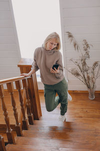 Full length of woman standing on wooden floor