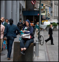 People on sidewalk in city