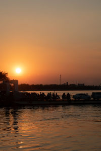 Scenic view of river against sky during sunset