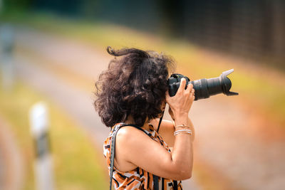 Rear view of woman photographing