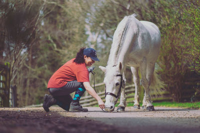 Side view of person with umbrella against plants