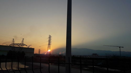 Silhouette city against sky during sunset