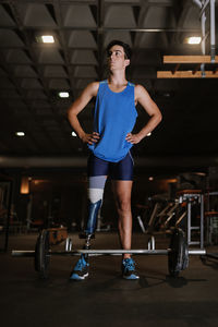 Man with artificial leg standing in gym