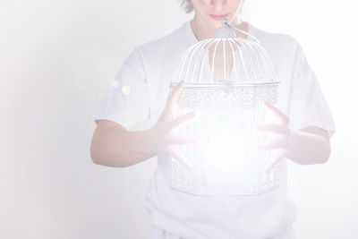 Midsection of a woman holding white background