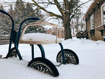 Close up of snow covered tricycle