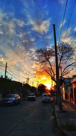 Cars on road at sunset