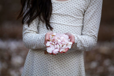 Midsection of woman with bouquet