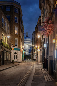 Street amidst buildings in city at night