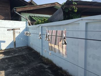 Clothes hanging on house by building