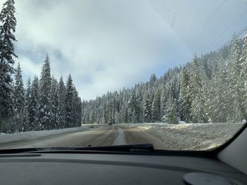 Road seen through car windshield during winter