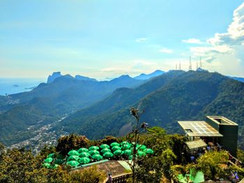 Scenic view of mountains and buildings against sky