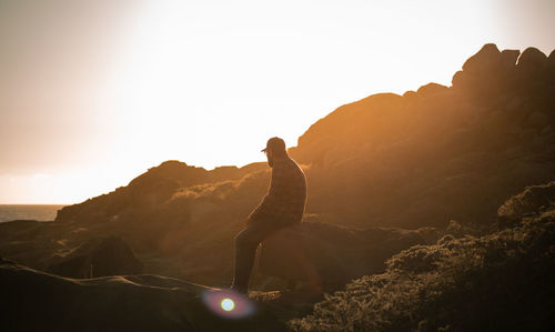 Man with mountain range against sky