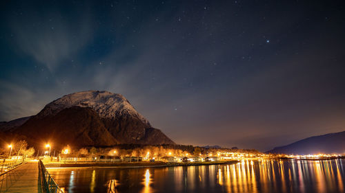 Scenic view of lake against sky at night