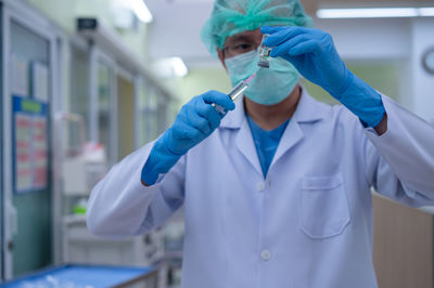 Mid section of a man holding umbrella