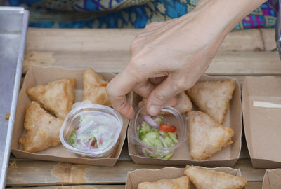 Cropped hand of person preparing food