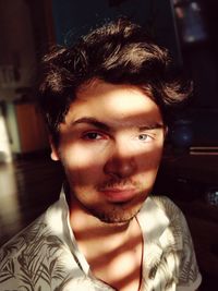 Portrait of young man sitting at home