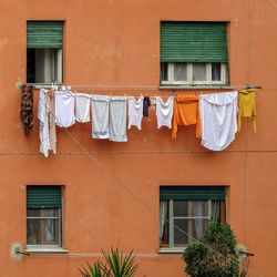 Low angle view of clothes drying against building