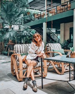 Full length of woman sitting on chair