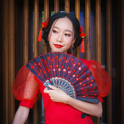 Young woman holding red umbrella