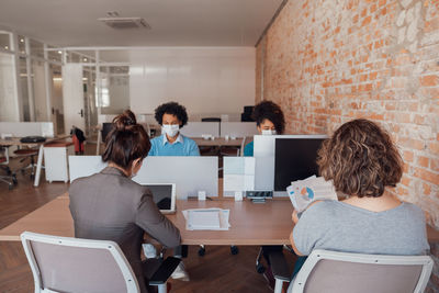 Business persons wearing mask working at office