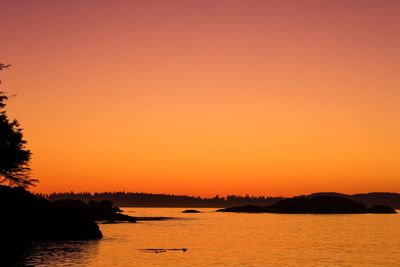 Scenic view of sea against orange sky