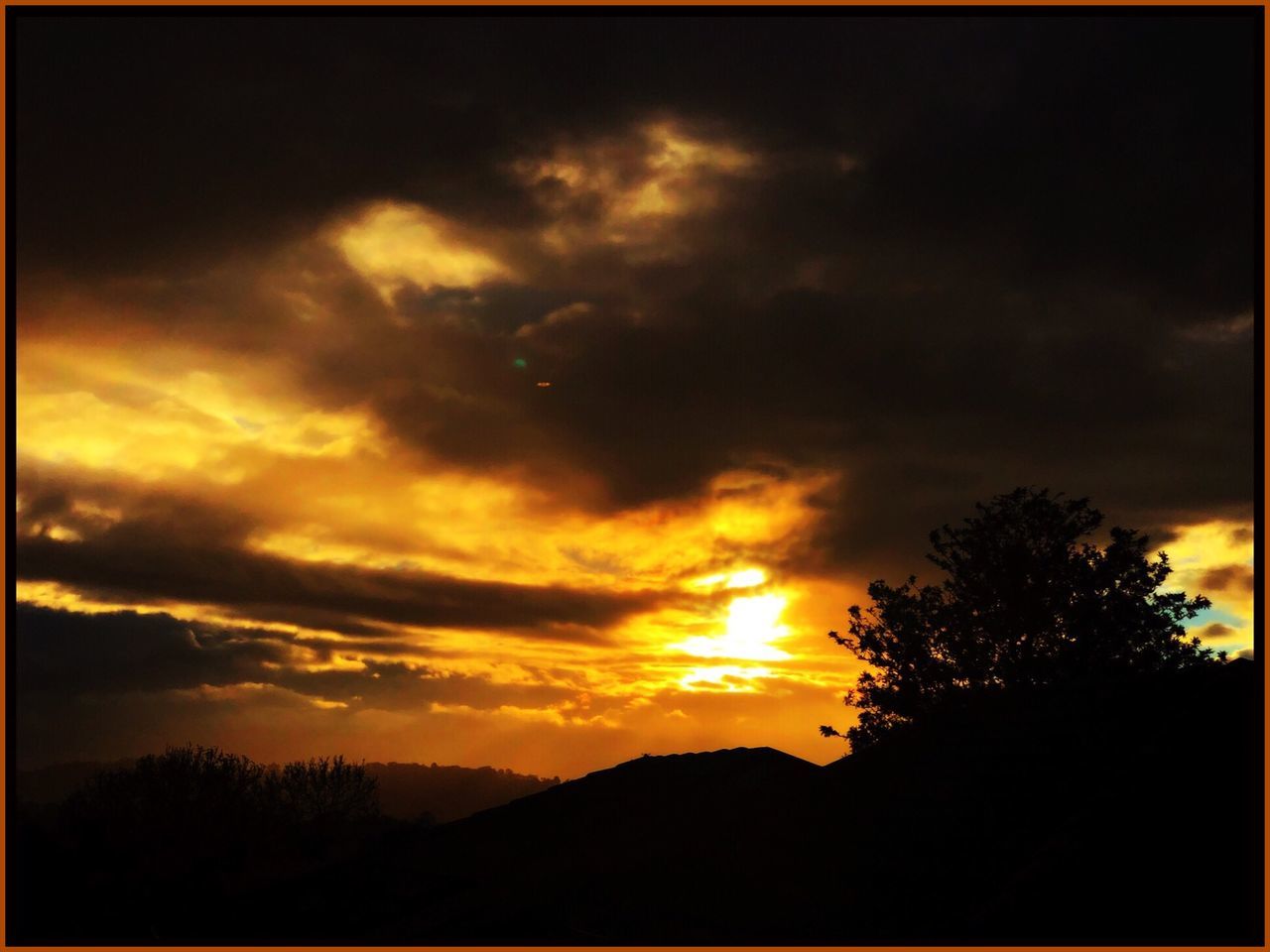 sky, cloud - sky, sunset, beauty in nature, scenics - nature, silhouette, tranquil scene, tranquility, tree, orange color, plant, no people, nature, idyllic, environment, dramatic sky, transfer print, landscape, auto post production filter, outdoors, dark