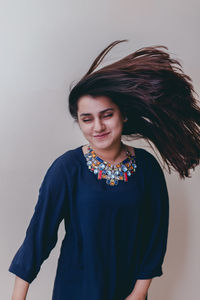 Portrait of young woman tossing hair