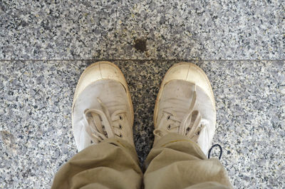 Low section of man standing on footpath