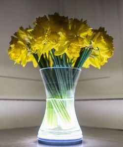Close-up of yellow flower vase on table